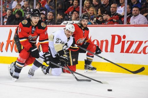 Mikael Backlund, Craig Adams, T.J. Brodie